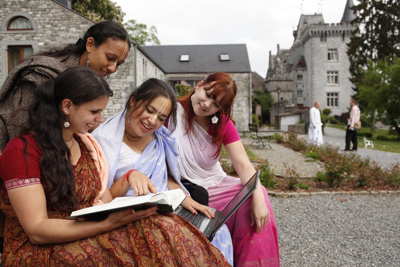 Young women studying together at an ISKCON community